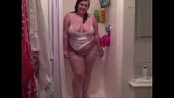 Chubby young chick getting naked in the shower