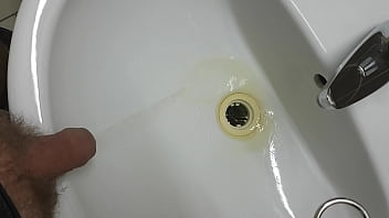 a pee in a sink in a public toilet