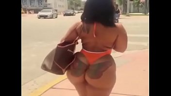 sexy latina in swimsuit walking on the street